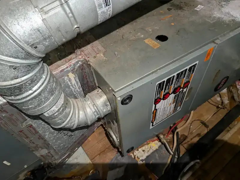 Rheem RGRS-07EAMGR gas furnace in a mixed-brand residential HVAC system